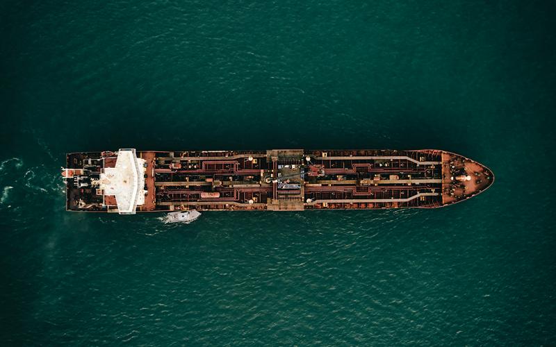 Aerial view of a tanker with a service launch alongside