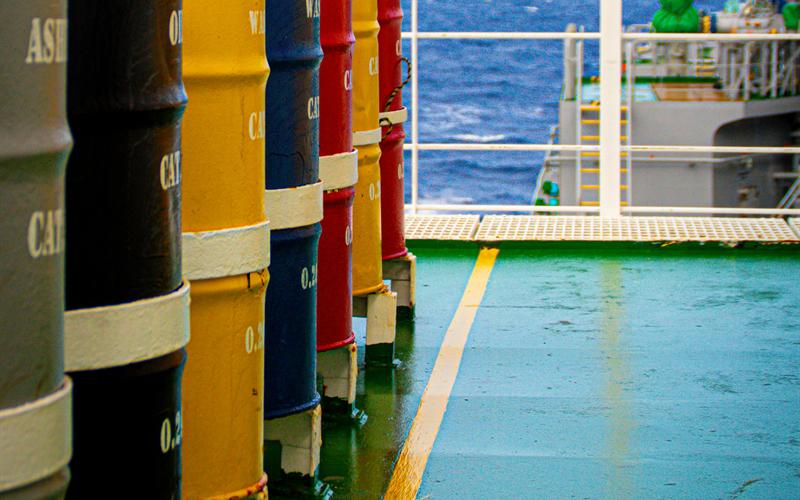 Drums of lubricants and stores lined up on a ship's deck